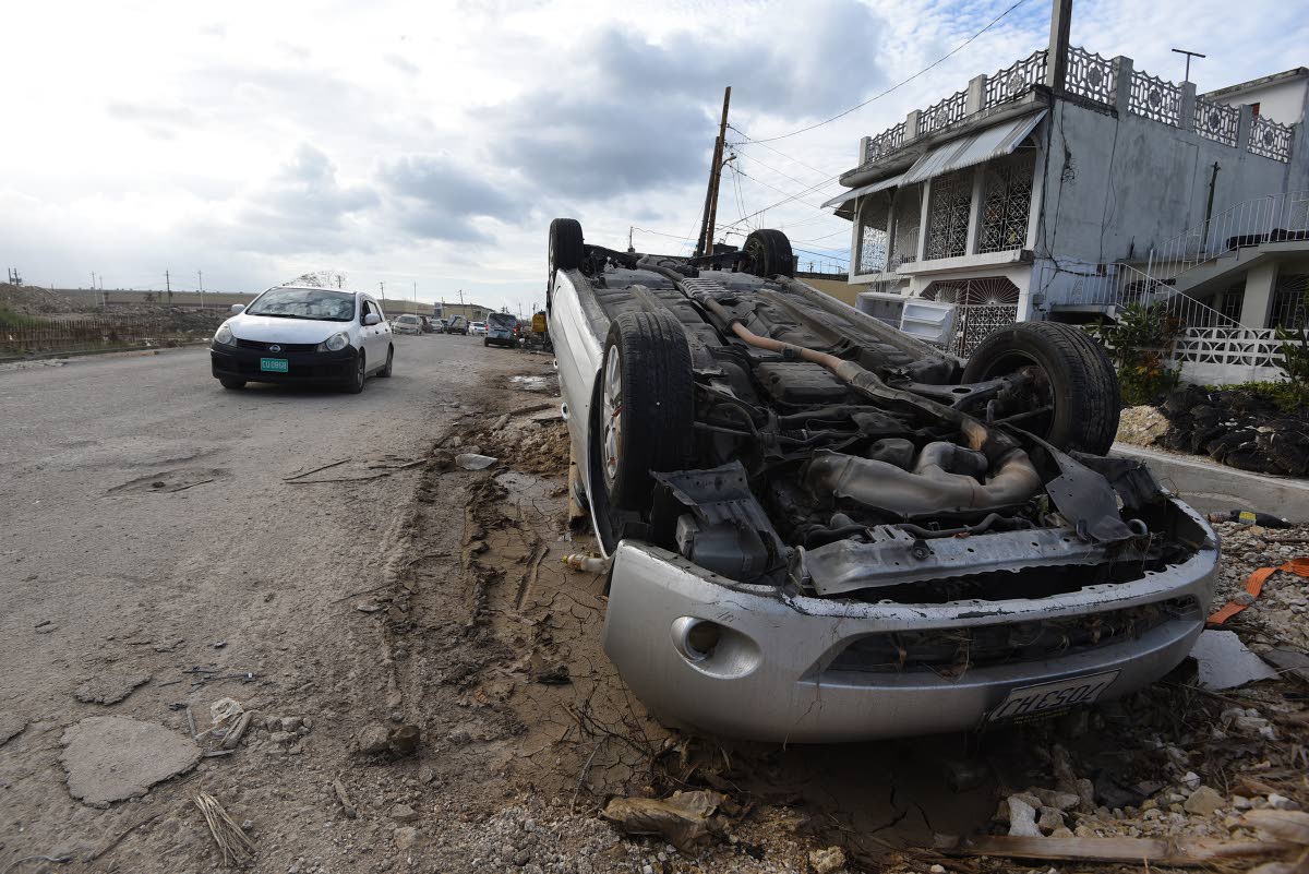 An overturned car among the rubble in Catherine Hall following the passage of Hurricane Melissa late last year.