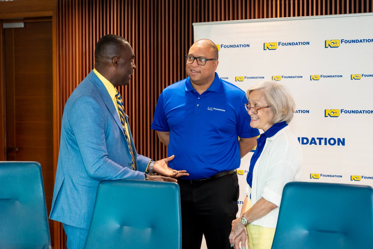  Lynton Weir (left), principal of Old Harbour High School, engages in conversation with Perrin Gayle, CEO of NCB Foundation and Thalia Lyn, chair, NCB Foundation, following the recent MOU signing at The Atrium in St Andrew.