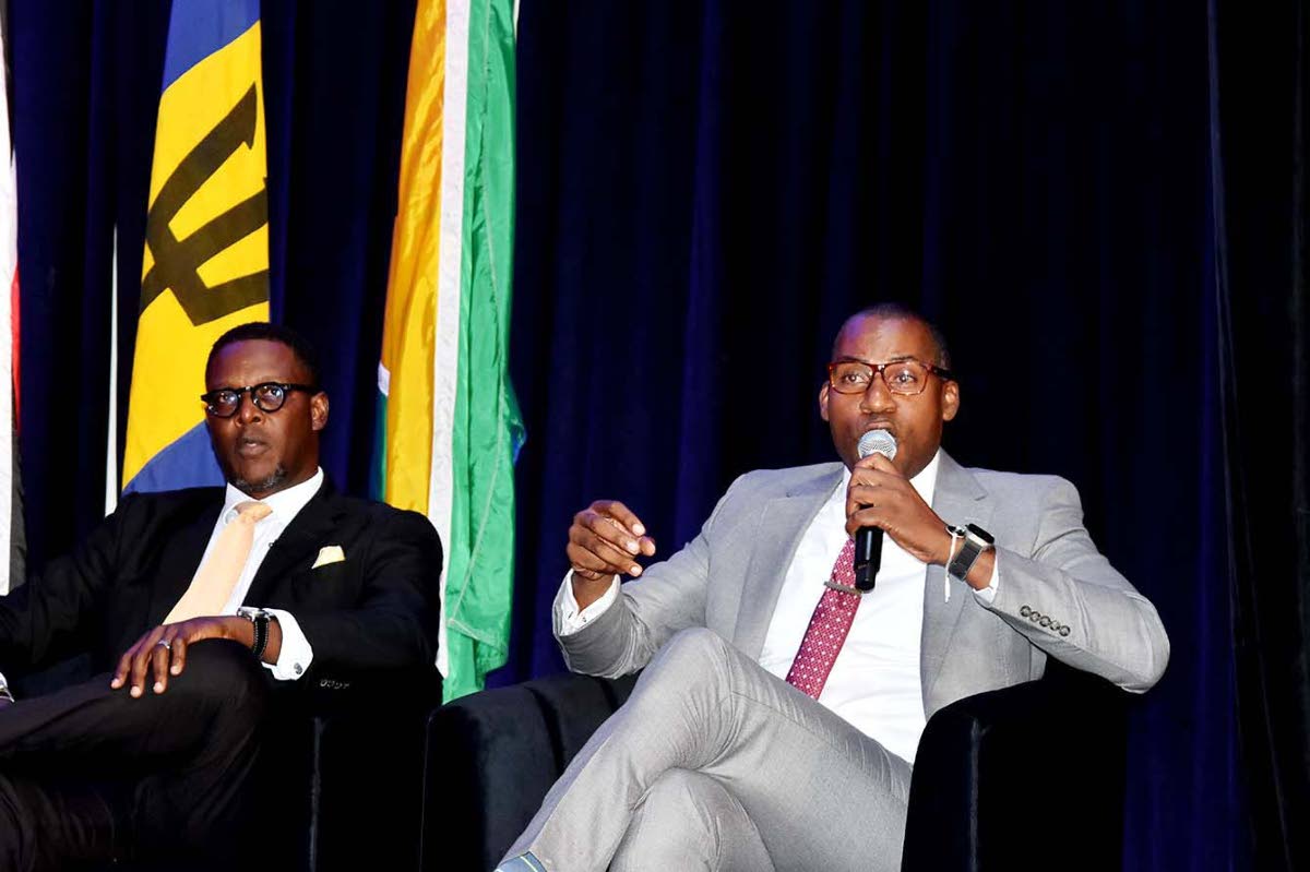 Hugh Grant (right), president and chief executive officer of the Jamaica Public Service, and Stephen Price, vice-president and general manager of FLOW Jamaica, speak on a panel during the Utility Service Providers round-table at the OOCUR 20th anniversary 