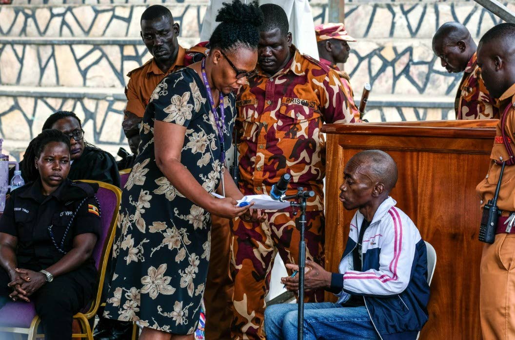 Christopher Okello Onyum, a man accused of killing four children, appears in court at the Ggaba Community Church grounds in Kampala, Uganda, Monday, April 13, 2026. 
