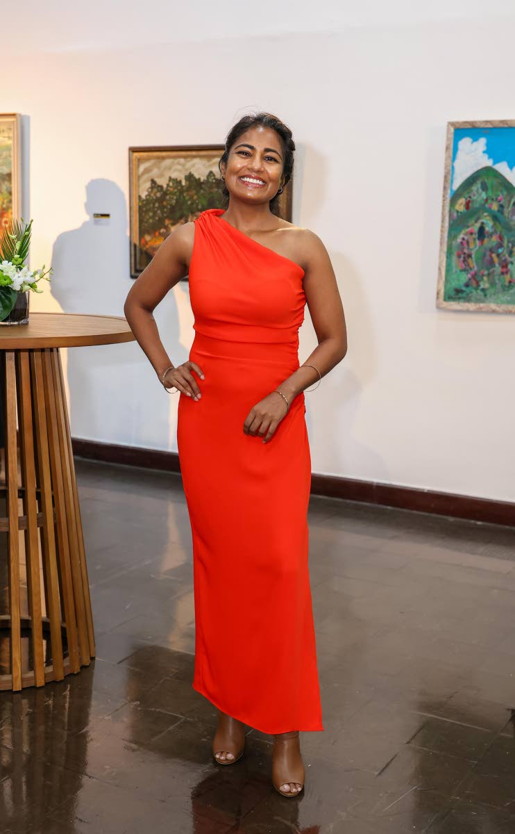 Shalini Jagnarine-Azan, director of Pothos Limited, embraces bold colour for the evening, complementing the warmth of her smile.
