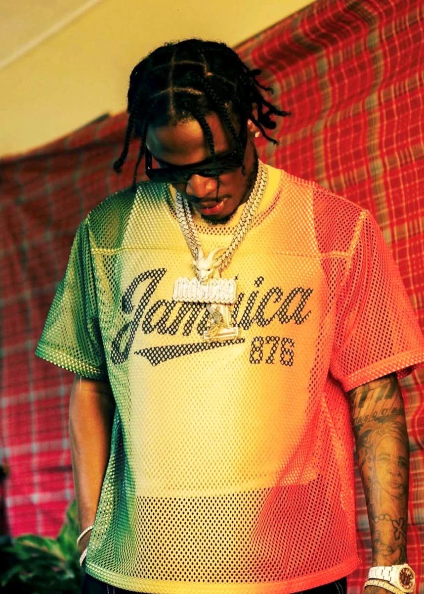 Dancehall artiste Masicka dons the red, gold and green Represent Jamaica Roots Mesh Jersey.