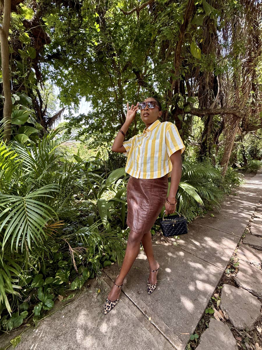 McLeggon elevates everyday style in a yellow-and-white striped top from Lee’s Fifth Avenue and her own brown skirt design, finished with leopard-print mules, a Heel-O bag and SHEIN sunglasses.