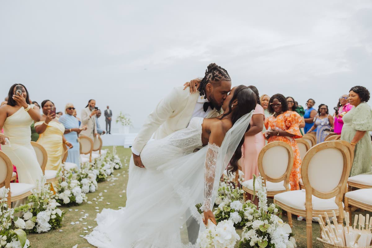 Noel dips his bride into a kiss.