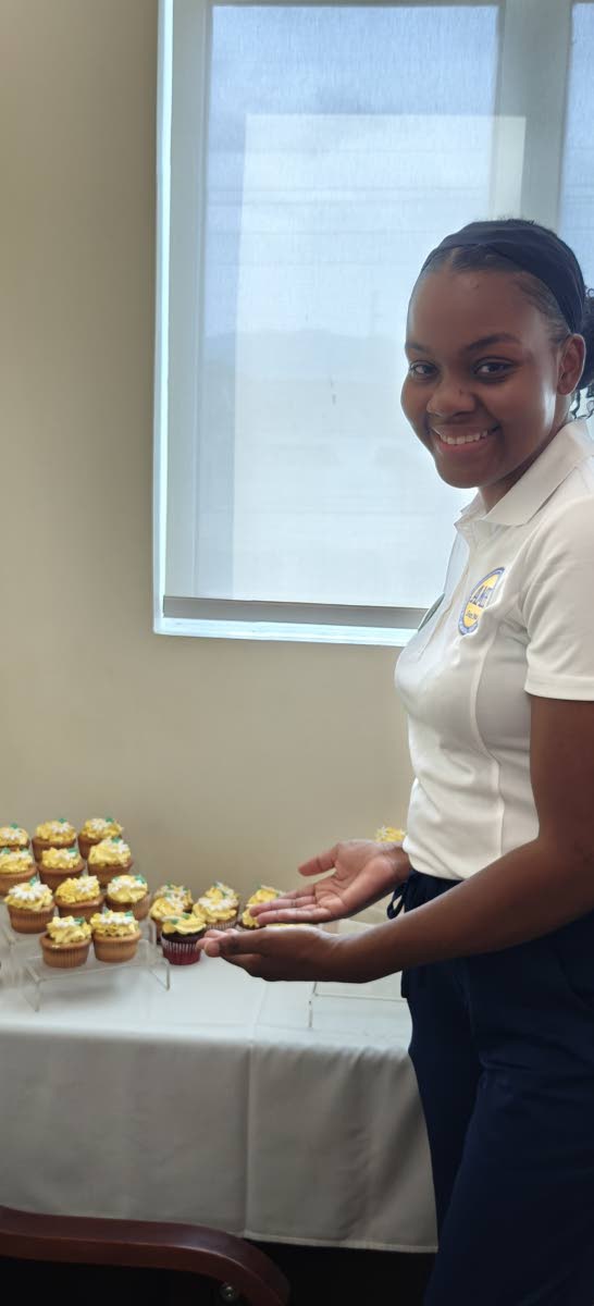 Karlene Armstrong, coordinator of professional development and clinical excellence at Andrews Memorial Hospital, displays the beautifully decorated DAISY-themed cupcakes at the award programme’s launch.