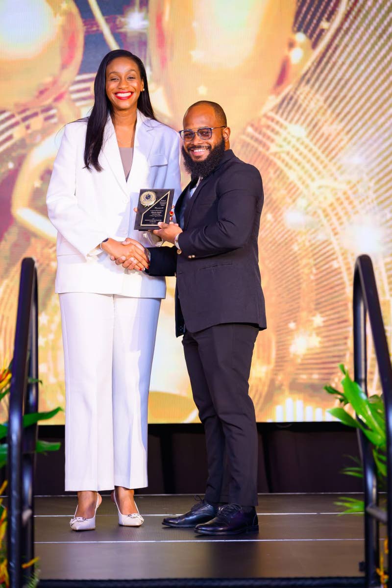 Rhoda Crawford (left), minister of state in the Ministry of Education, Skills, Youth and Information, presents Aberdeen High School Principal Audley Feare with the Outstanding Leadership in Education award during the Region Five Principals’ Recognition a