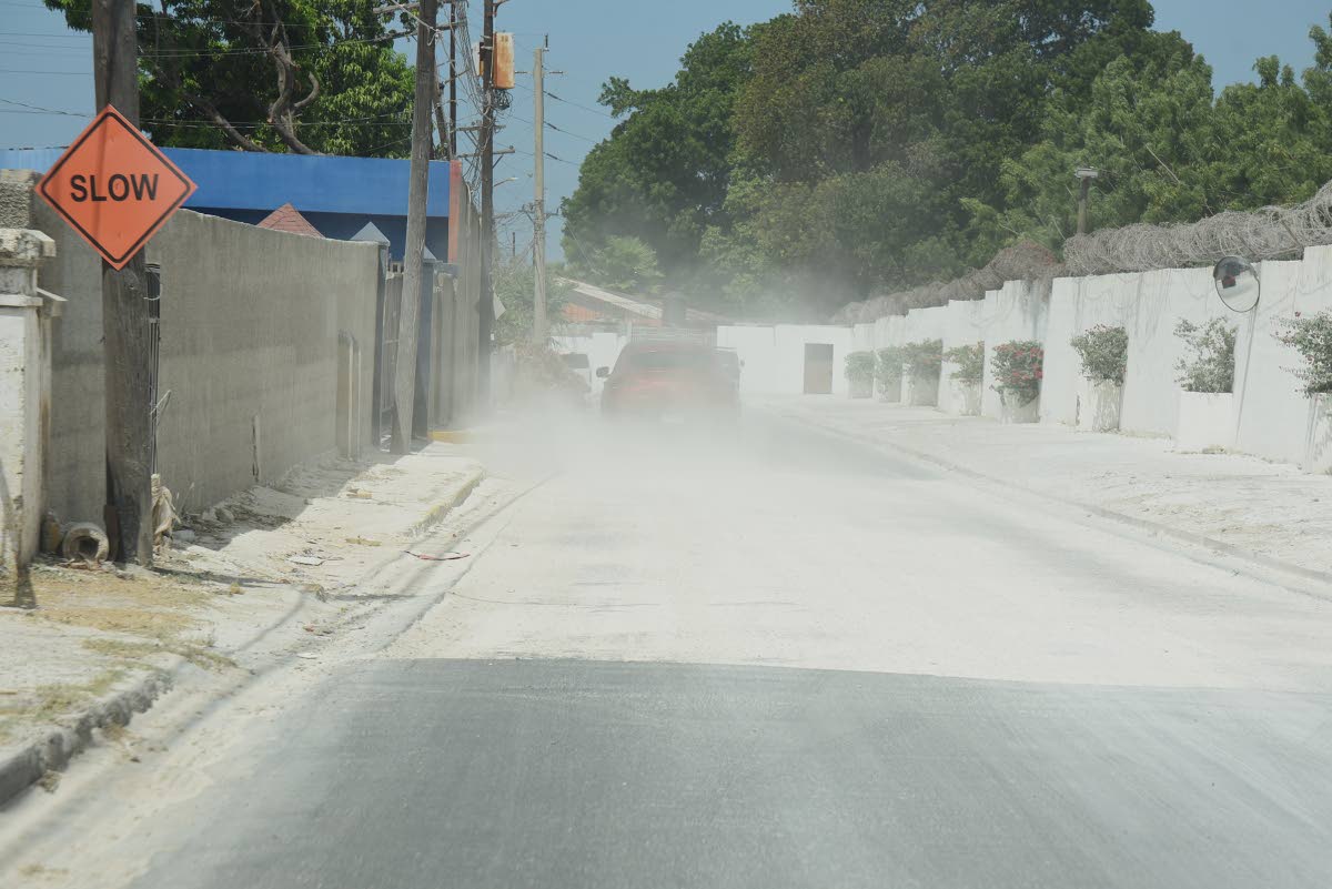 A section of Vineyard road in Vineyard Town, St. Andrew, that is left to be asphalted, is causing a dust nuisance to residents of the area from motorist who refused to slow down while driving through the area.
