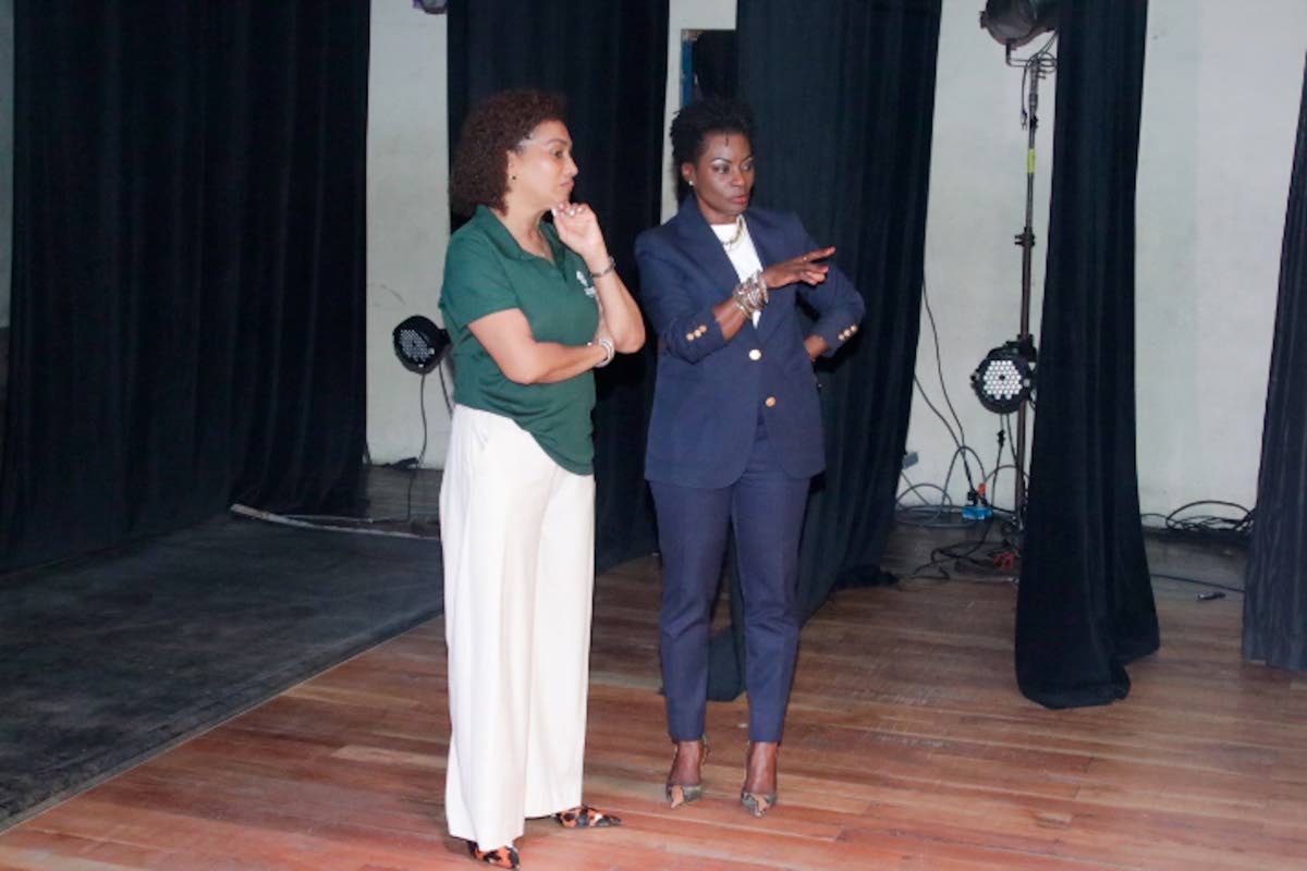 Heather Goldson (left), director, Supreme Ventures Foundation, and Marisa Benain, executive director of the Little Theatre, review the theatre’s stage during a recent visit to the facilities. 