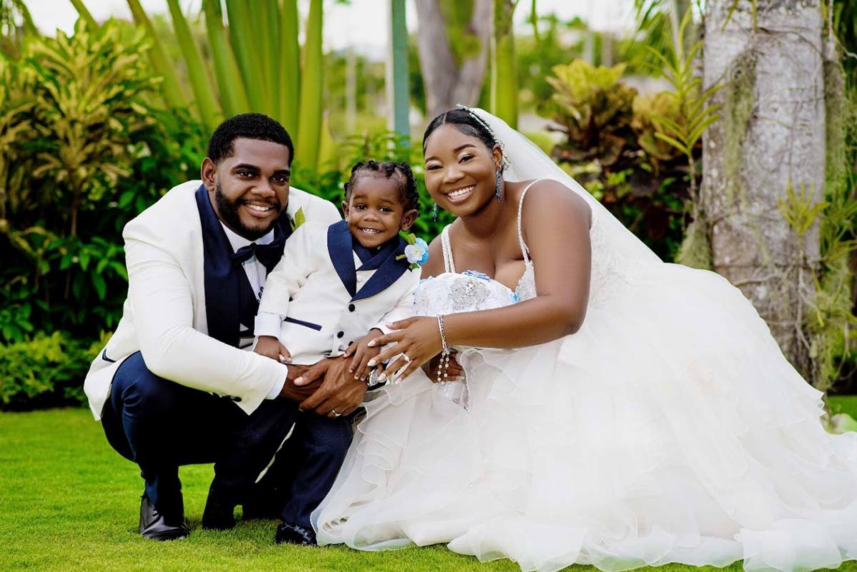 Tajay (left) and Paige-Marie share this picture-perfect family moment with their son Azaire, who served as their ring bearer.