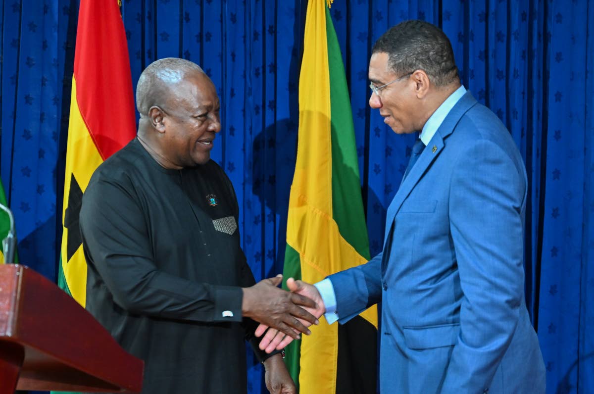 Prime Minister Dr Andrew Holness (right) greets President of the Republic of Ghana, John Dramani Mahama, ahead of a press conference following bilateral talks at the Office of the Prime Minister yesterday.