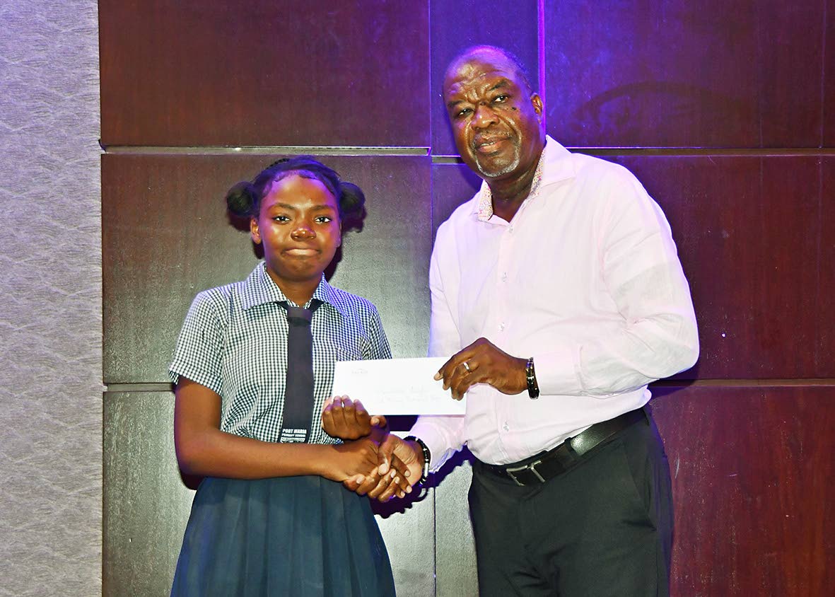 Renesha Anglin accepts her grant from Moon Palace Vice-President Clifton Reader. Anglin, a graduate of Port Maria Primary School, will begin studies at St Mary Technical High School in September.
