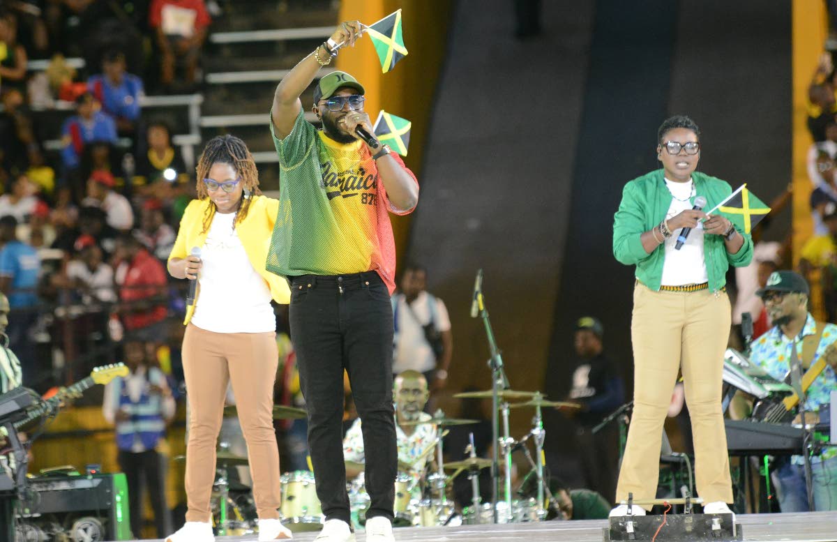 Gospel artiste Kevin Downswell raises the Jamaican flag high as he ministers in song.
