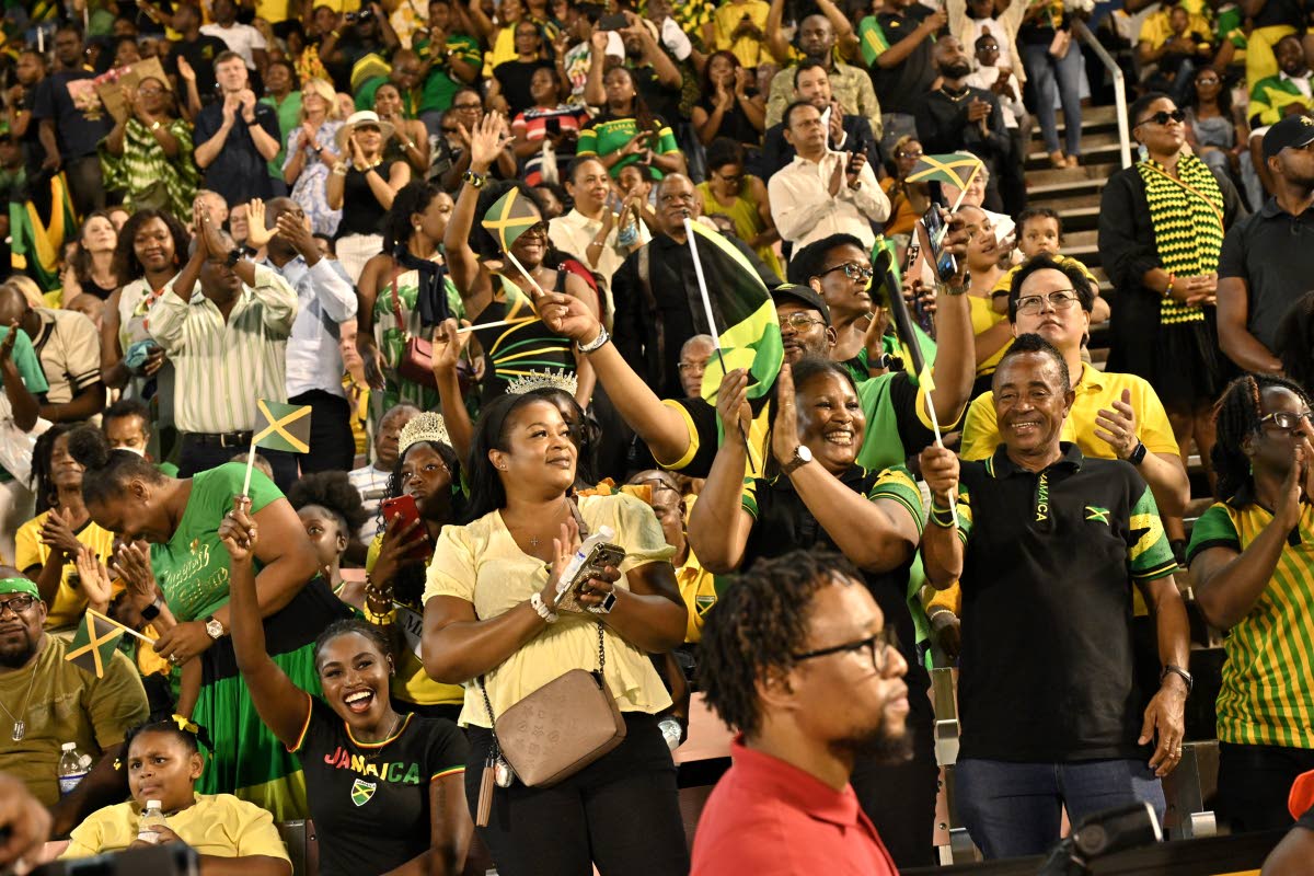 Jamaicans across the island wave their flags while repping the black, green and gold on Independence Day at the National Stadium.