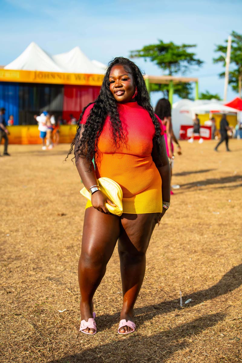 Property manager Titania Barrett plays with warm tones in an ombré knit one-piece, pairing the look with a butter-yellow pouch clutch.