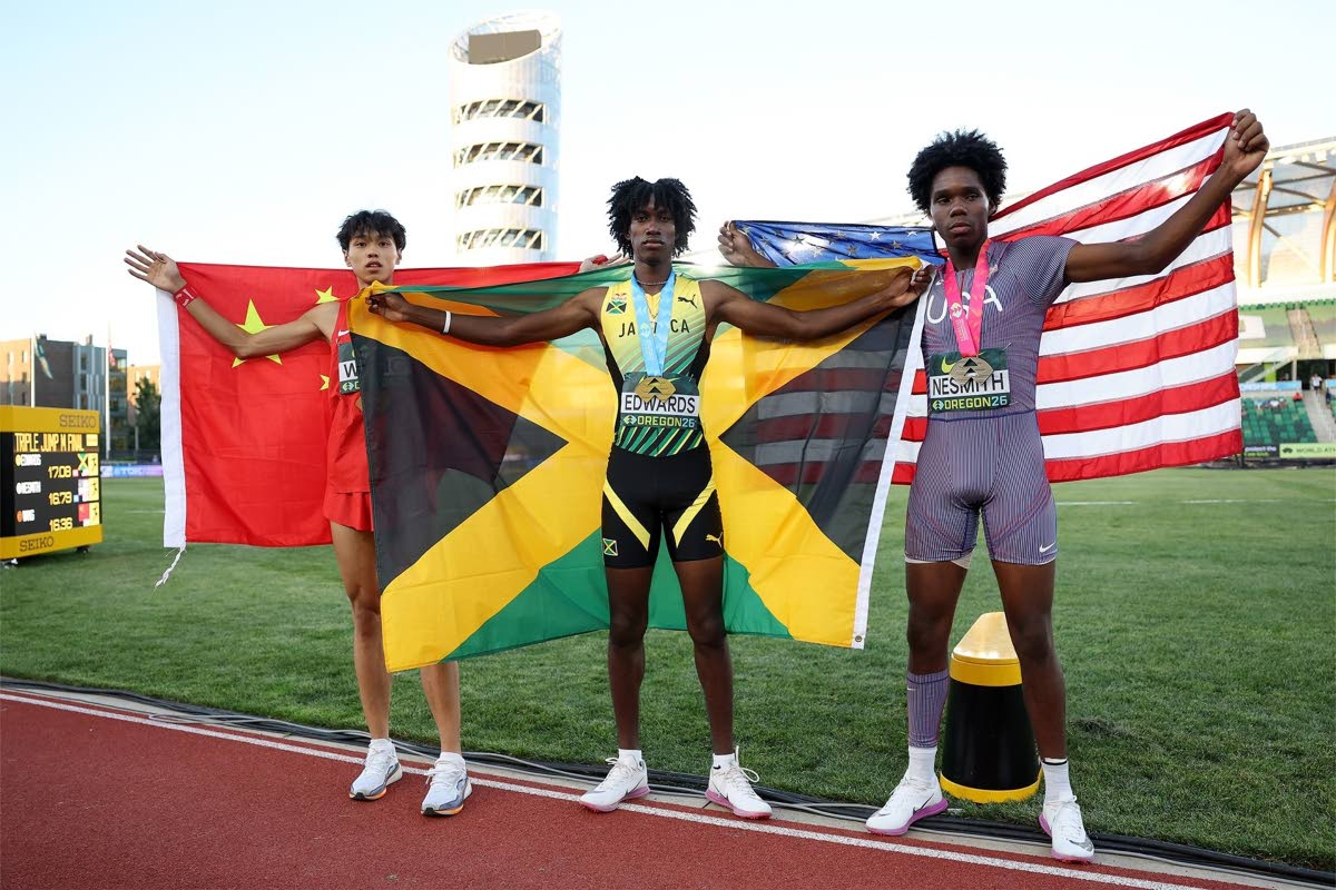 From left: China's Zhuoyue Wang, Jamaica's Michael-Andre Edwards, and the United States' Miles Nesmith celebrate the medals they earned in the triple jump at the World Athletics Under-20 Championships at Hayward Field in Eugene, Oregon, yesterday. 