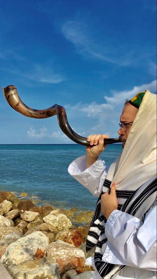 Jamaica’s Rabbi sounds the ram horn, known as the shofar.