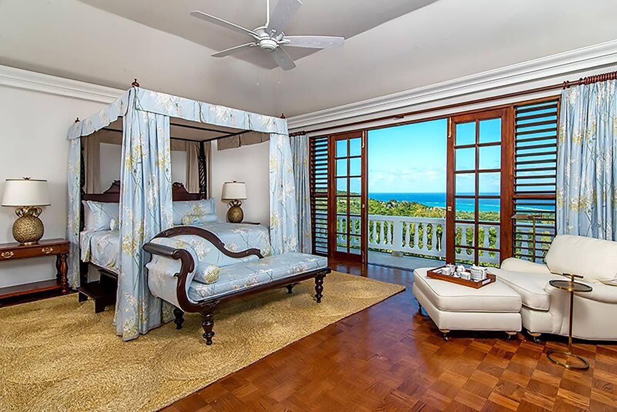 A canopy bed highlights this bedroom, which offers wide sea vistas.