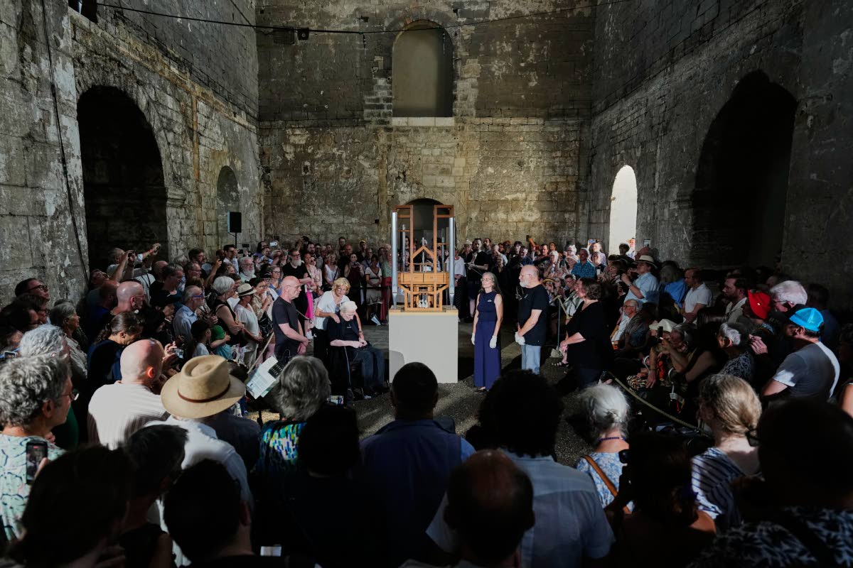 People listen to the sound of the John Cage Organ Project Halberstadt during a chord change of the organ inside the medieval Burchardi Church.