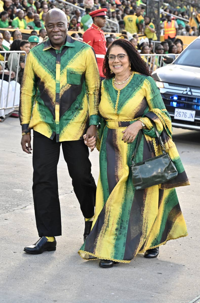 Bryan Sykes, chief justice of Jamaica, arrives with his wife, Dr Annette Crawford-Sykes, in coordinated Jamaican-flag-inspired outfits.