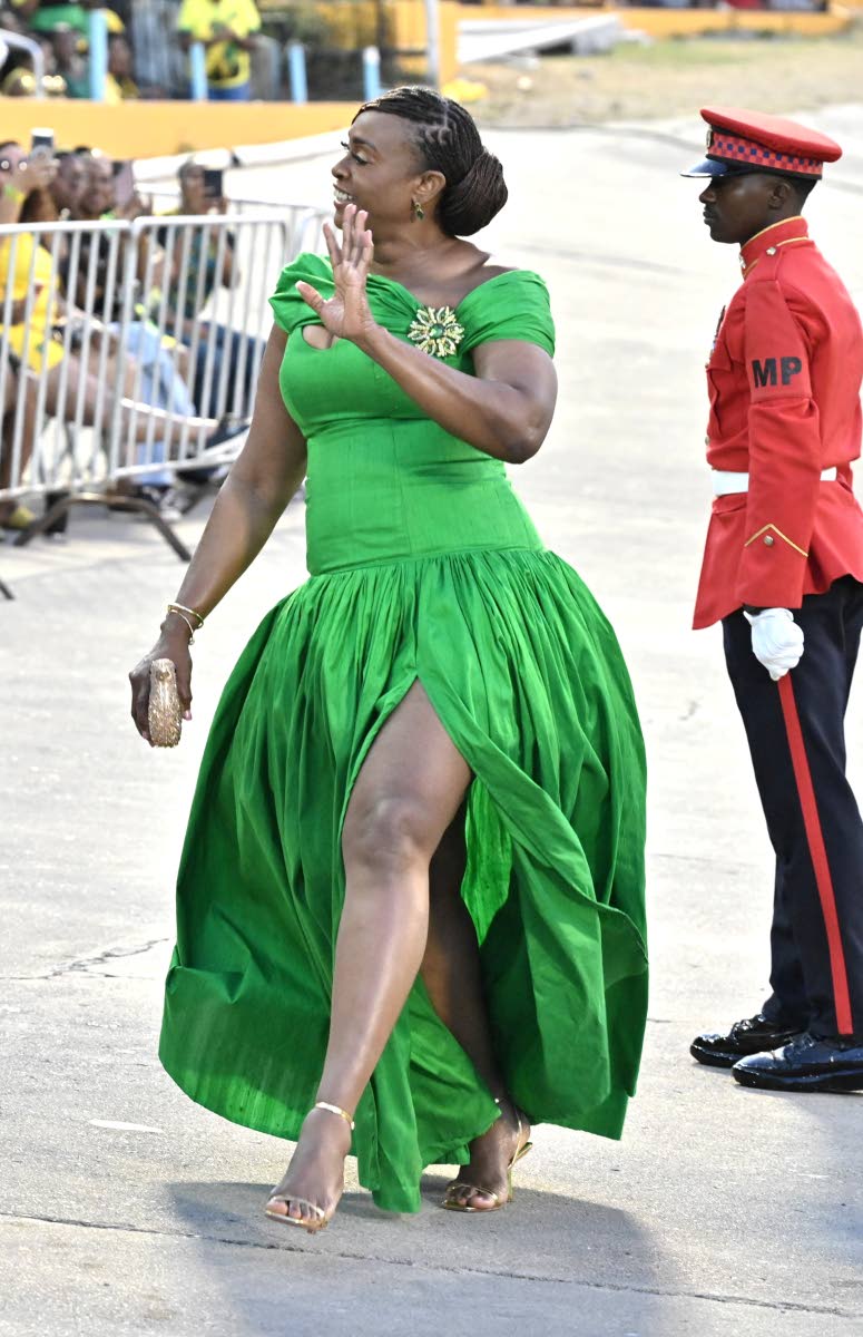 Juliet Holness, speaker of the House of Representatives, puts her best foot forward in a vibrant green gown with a large brooch detail, a high slit and strappy golden sandals. 