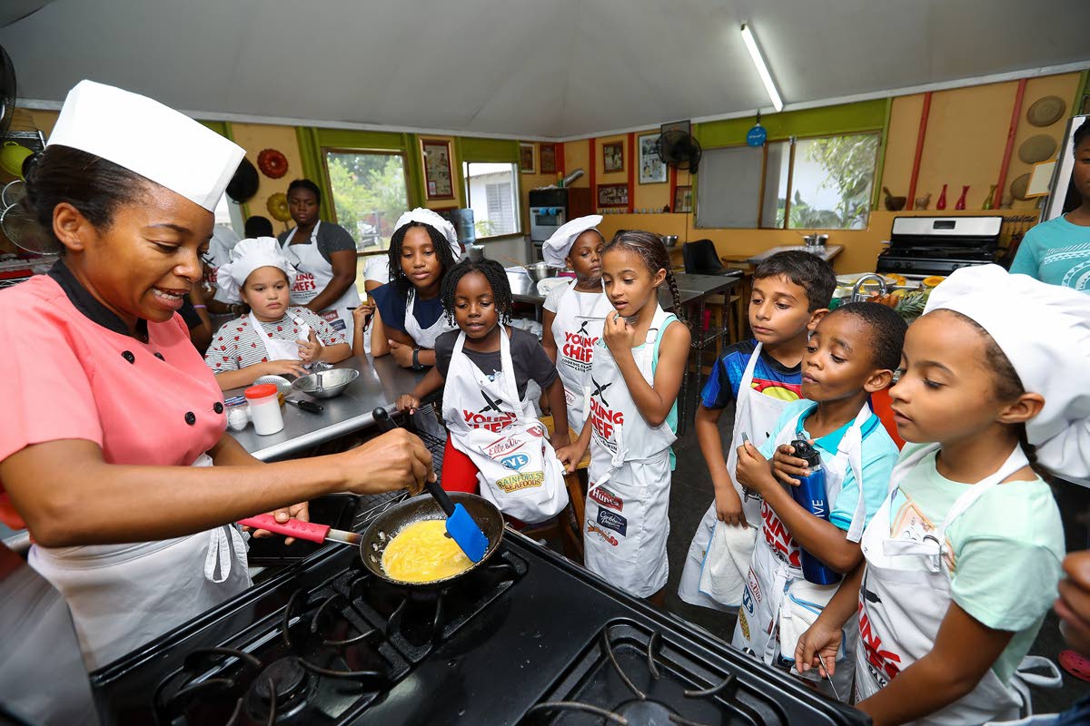 Latoya Panton, chef and founder of the Young Chefs Cooking Club, guides young participants through the preparation of scrambled eggs.