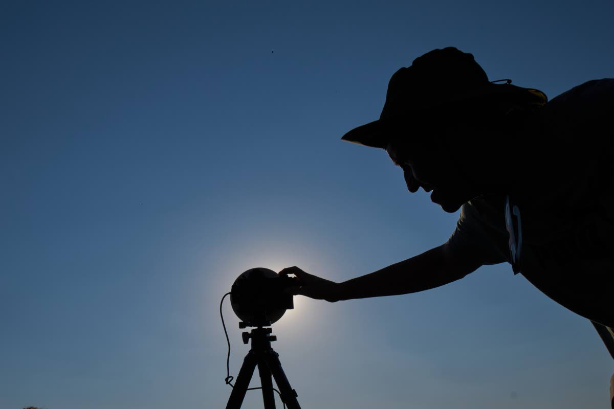 A member of the ‘Los Taraos’ amateur astrophotography group, sets up his camera to shoot a total solar eclipse in Berlanga de Duero, central Spain, Wednesday.