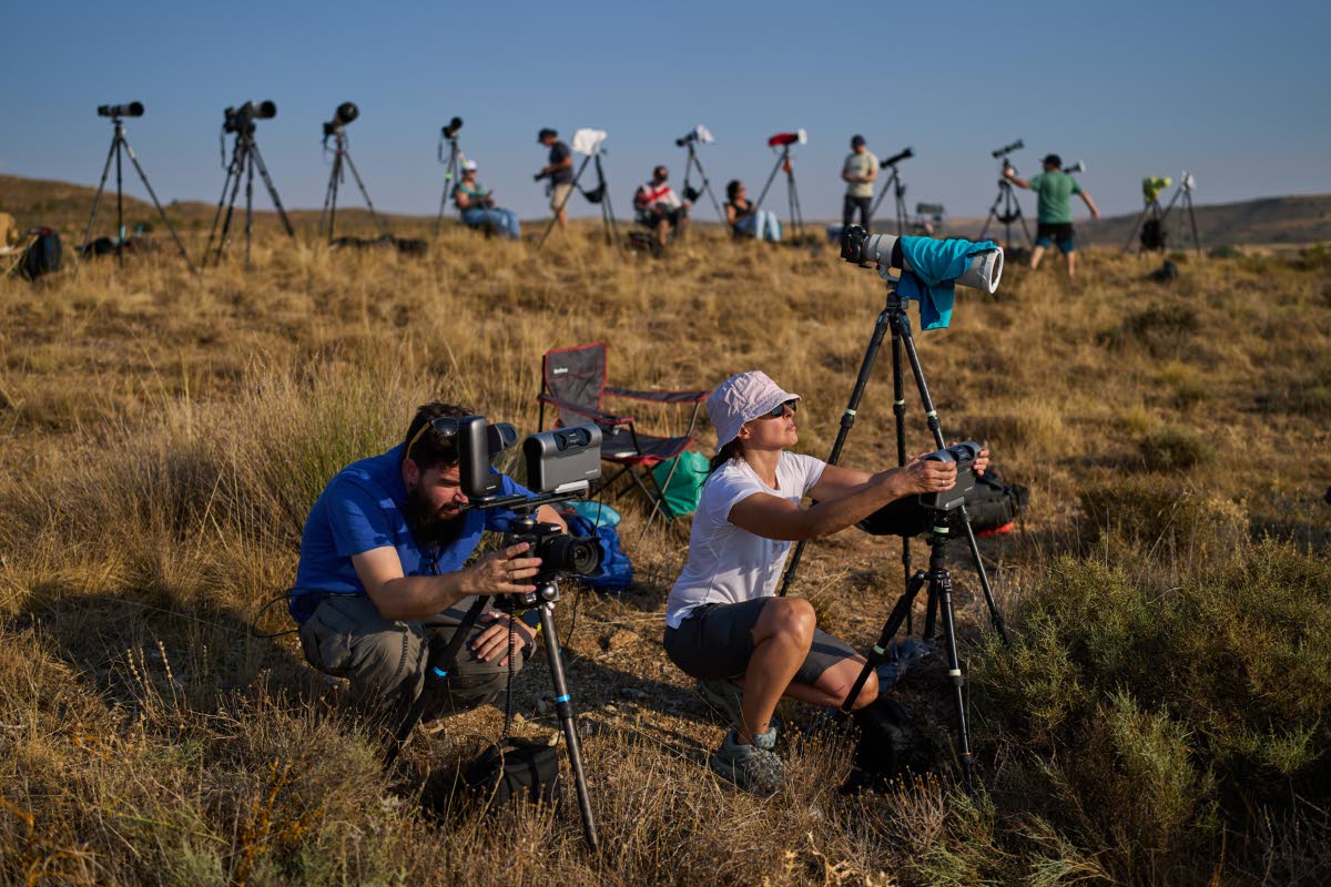 Members of the ‘Los Taraos’ amateur astrophotography group, set up cameras to shoot a total solar eclipse in Berlanga de Duero, central Spain, Wednesday.