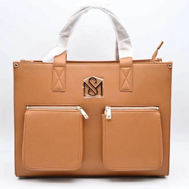 The tan SM Kollection Tote brings a neutral touch to the latest drop and is designed to transition effortlessly across everyday looks.
