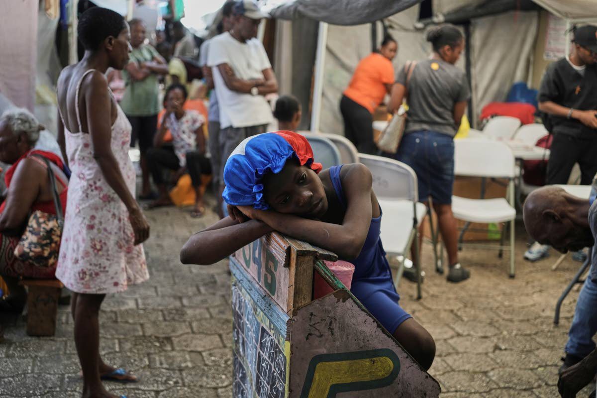 A girl rests at a shelter for families displaced by gang violence in Port-au-Prince, Haiti.