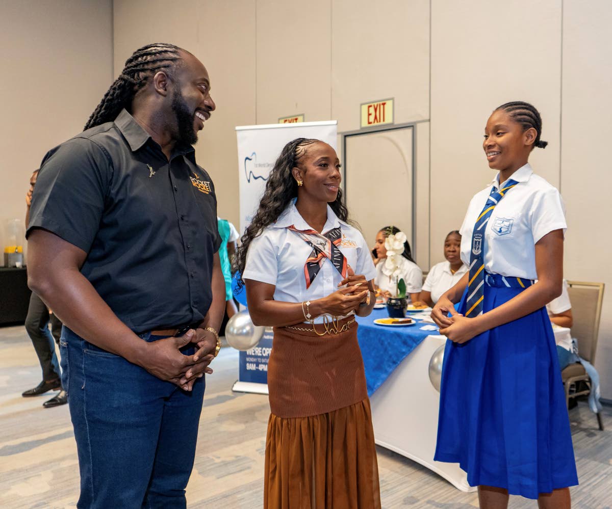 Pocket Rocket Foundation Founder and Chairwoman Shelly-Ann Fraser-Pryce (centre) and Executive Director Dr Jermaine McCalpin share a moment with Lysandra Taylor at this year’s staging of the foundation’s Student-Athlete Development Summit.