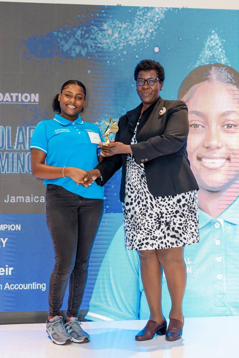 Alicia Weir (left), an NCB Foundation 2026 National Scholar, receives her award from Kennecy Davidson, Assistant Chief Education Officer in the Ministry of Education, Skills, Youth and Information, at the Foundation’s Scholars Awards & Mingle at The Jama