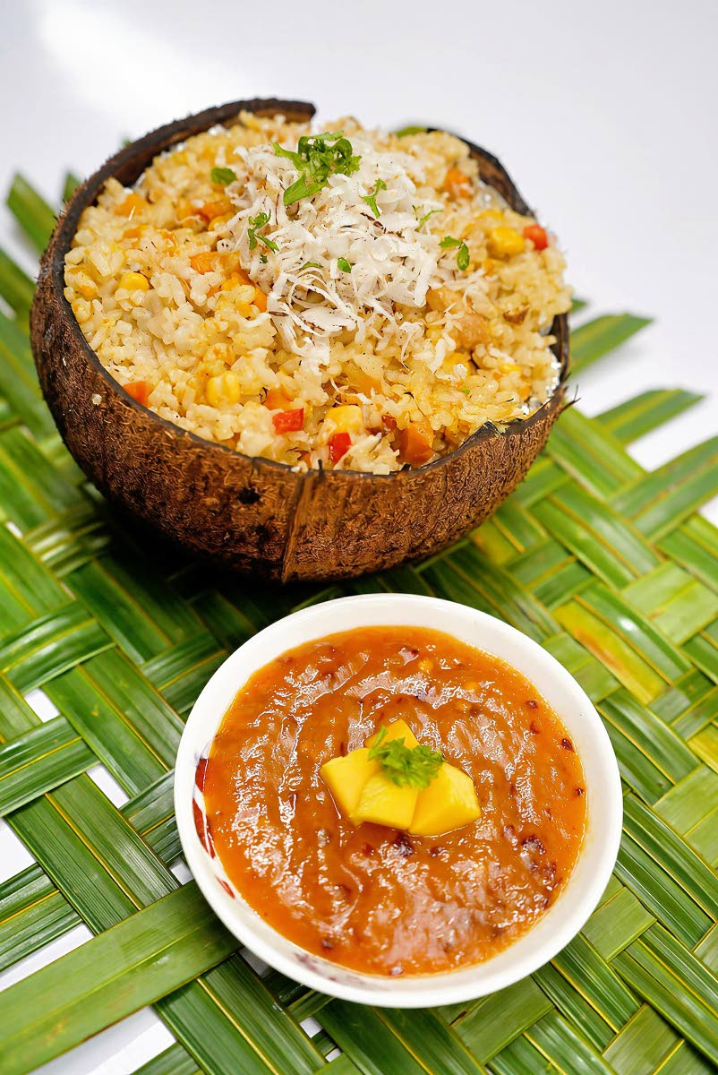 Coconut salt fish rice served inside a coconut shell. 