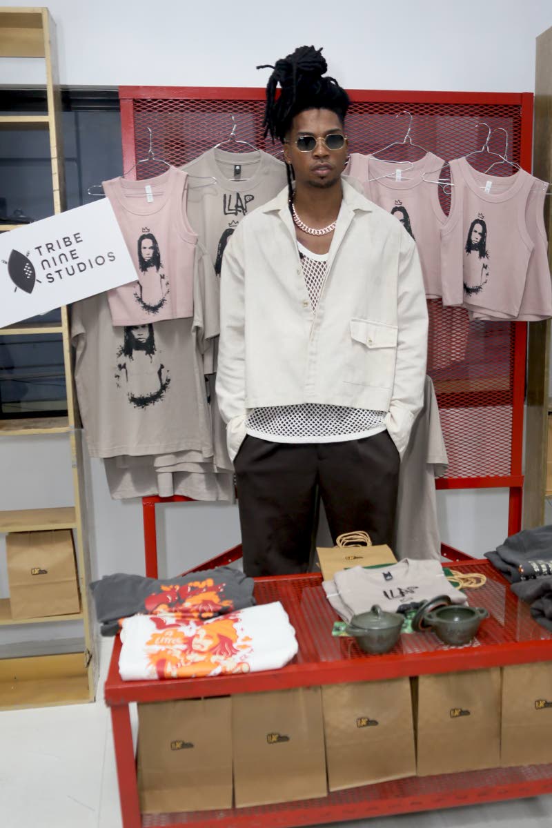 D’Yani poses at the merch booth featuring his D’Yani x Tribe Nine Studios ‘LLAP’ collaboration at his album launch on Friday at 105 Water Lane in downtown Kingston. The limited-edition collection features The Journey Tee, The Dutchpot Top and The B