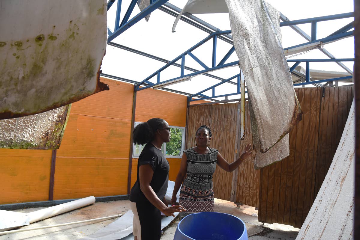 
Tanshea Williams-Johnson (left), vice-principal of St Mary Technical High School, and Marvalee Tomlinson-Russell, head of the Sixth Form Department, inspect the damaged sixth-form block at the school last week.