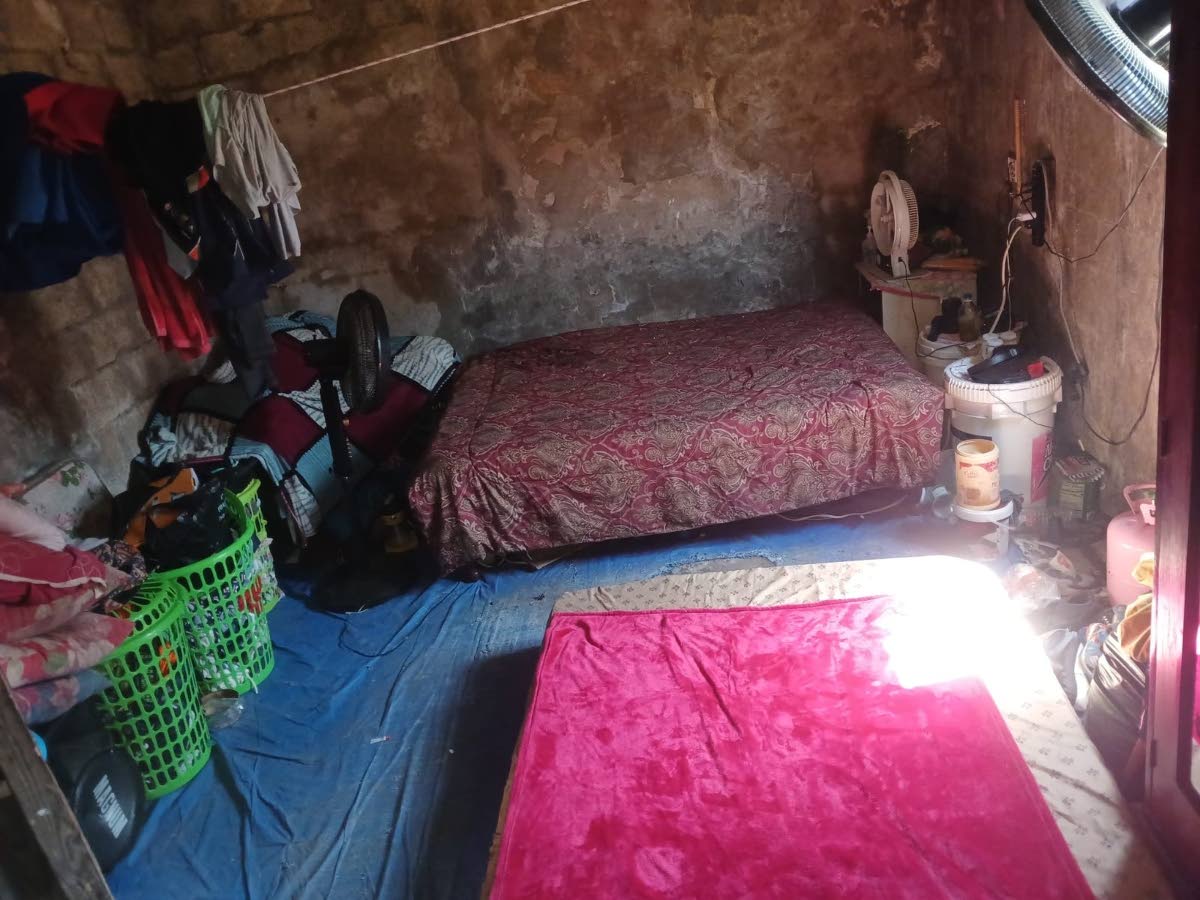 Inside the abandoned structure where the family now shelters.