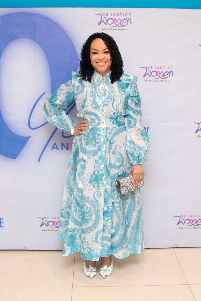 Dr Chrisann Simpson-Harley, obstetrician and gynaecologist, cuts a striking figure in an intricately patterned blue-and-white number, finished with complementary silver accents.
