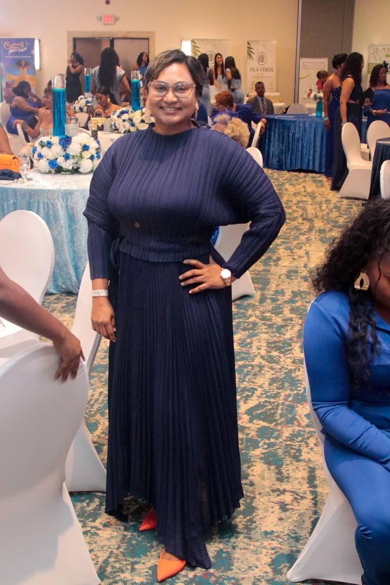 Nayana Williams, CEO of Lifespan Company Limited, punctuates her navy-blue look with a pop of orange.