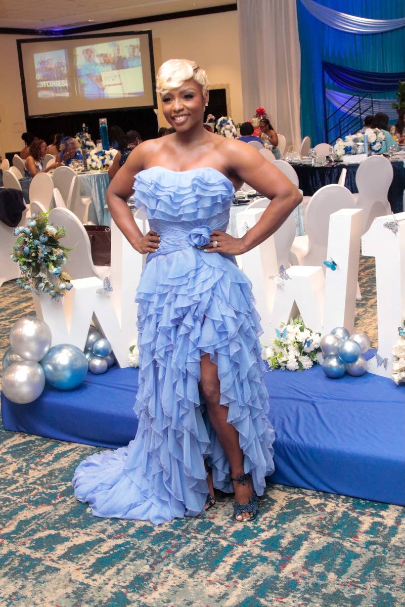We Inspire Women Brunch founder and CEO Cortia Bingham-McKenzie takes the stage in a Terani Couture gown featuring cascading ruffles and a sweeping train.