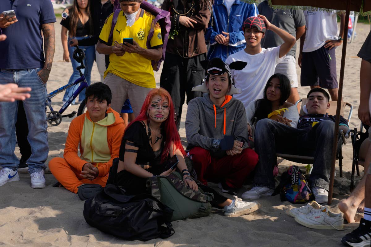 Aura farmers wait their turn to compete in aura-farming battles at Las Sombrilla beach in Lima, Peru, on August 29. 