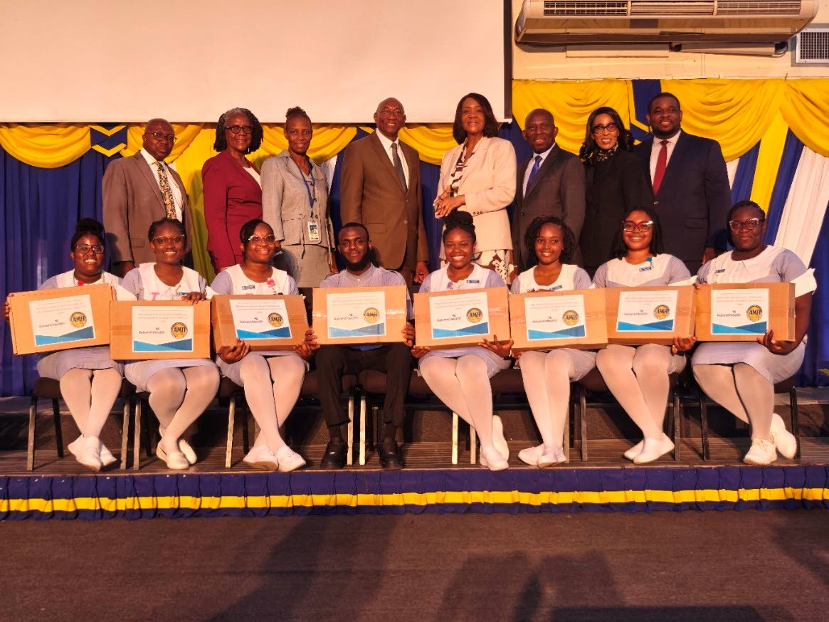 Eight nursing students who received their laptops from 100 are surrounded by officials (from left) Dr Paul Gyles, dean of graduate studies; Carolyn Marie Smith, associate vice president for spiritual development and student services; Dr Juliet Poyser, dire