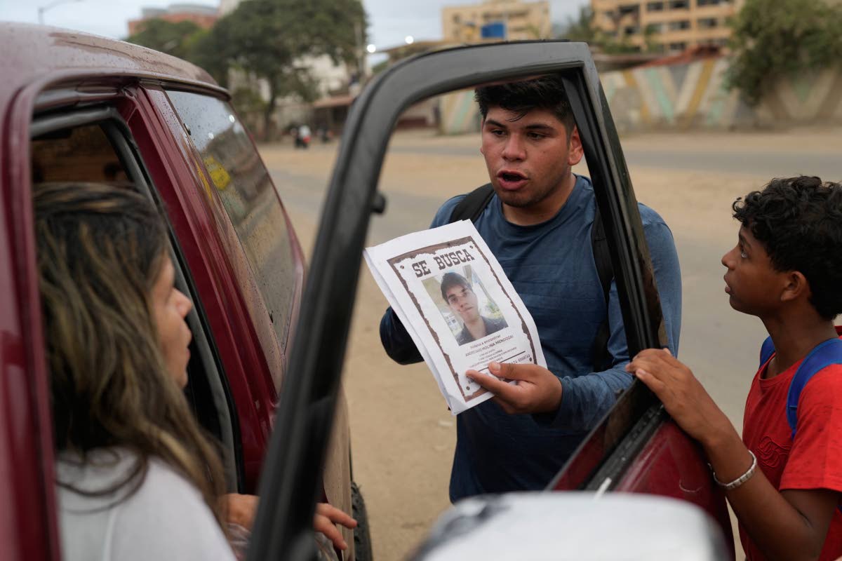 Pedro Gomez asks people about his cousin, Andres Molina, who has been missing since the earthquakes, in La Guaira, Venezuela, in August.