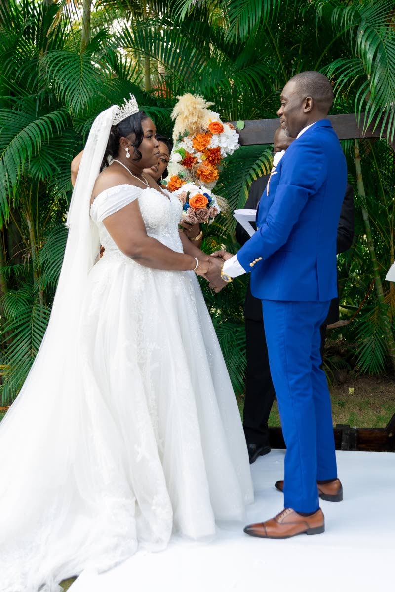 Hand in hand, the lovebirds exchange vows during their intimate garden ceremony at The Pavilion Garden at Hope Botanical Gardens.