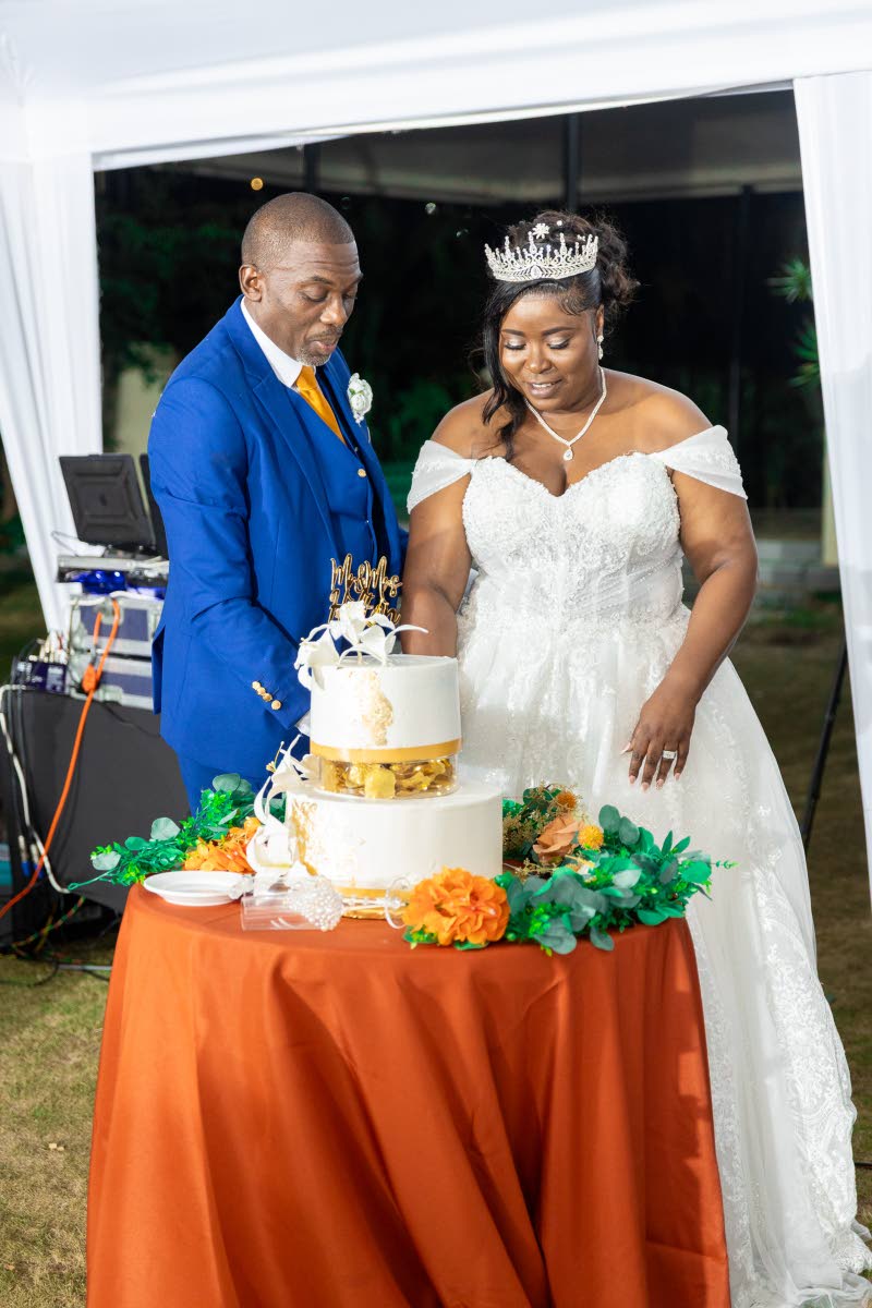 Mr and Mrs Hylton cut into their two-tier wedding cake, made with love by Events by Debbie.