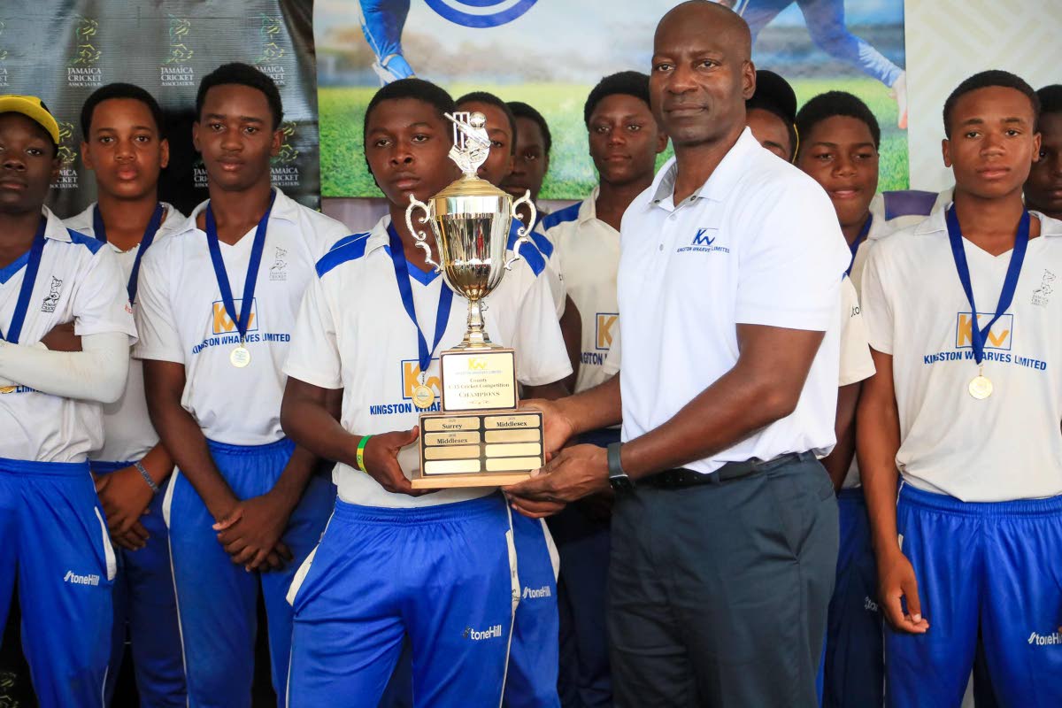 CEO Mark Williams presents the winners’ trophy to Middlesex in the 2026 Kingston Wharves Under-15 Competition, after that county defeated Surrey at the JDF field.