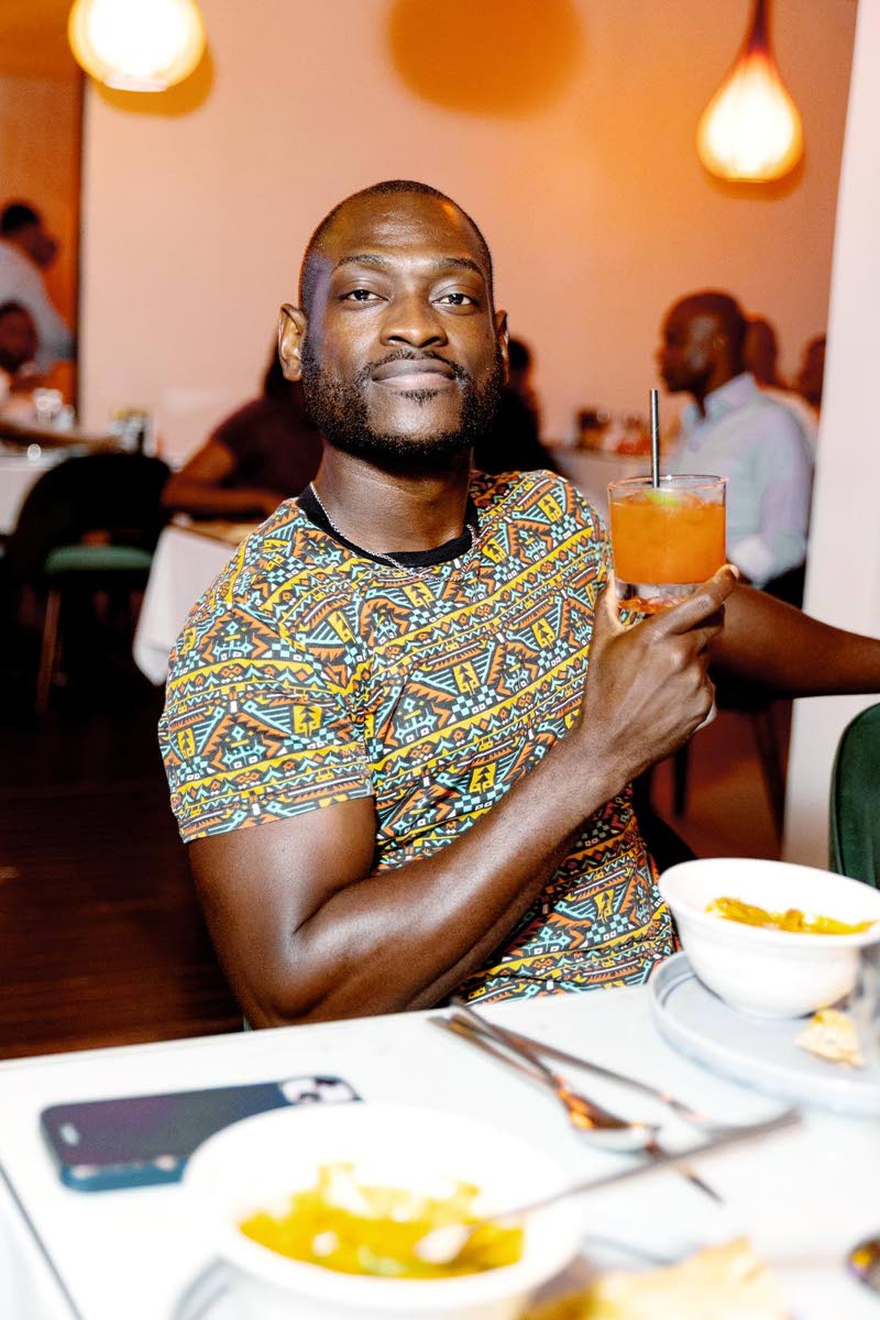 Content Creator Jermaine ‘Scotty Cuss’ Watson enjoys the Worthy storm pairing with the entrée, the shrimp jhinga curry with garlic naan.