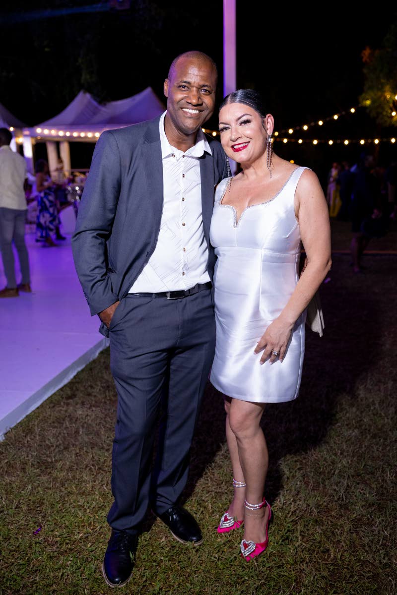 Rohan Harrison, acting senior director of insurance, Financial Services Commission, steps out in a slate blue suit, while Guardian General Insurance Jamaica Consultant Sheraley Bridgeman is chic in a white mini dress and pink heels.