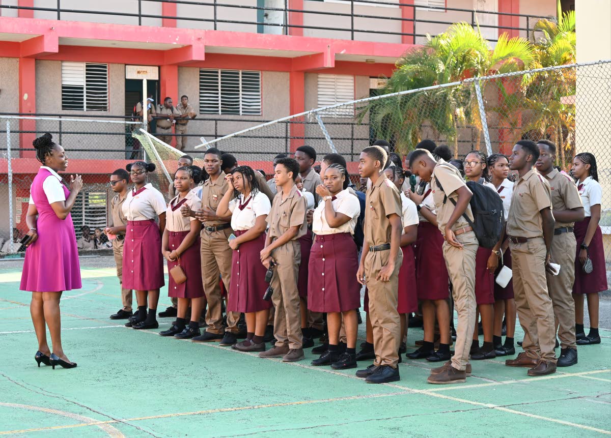 A group of prefects listen attentively to their teacher as she instructs them on the first day of school at Herbert Morrison Technical High School in Montego Bay, St James, last Monday.