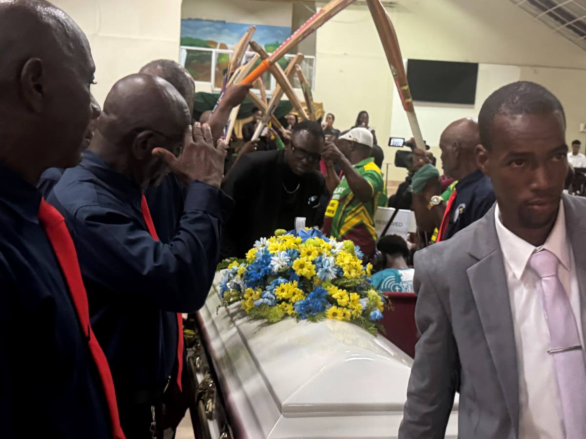 Members of the St James cricket fraternity form a guard of honour for Jerry Reid.

