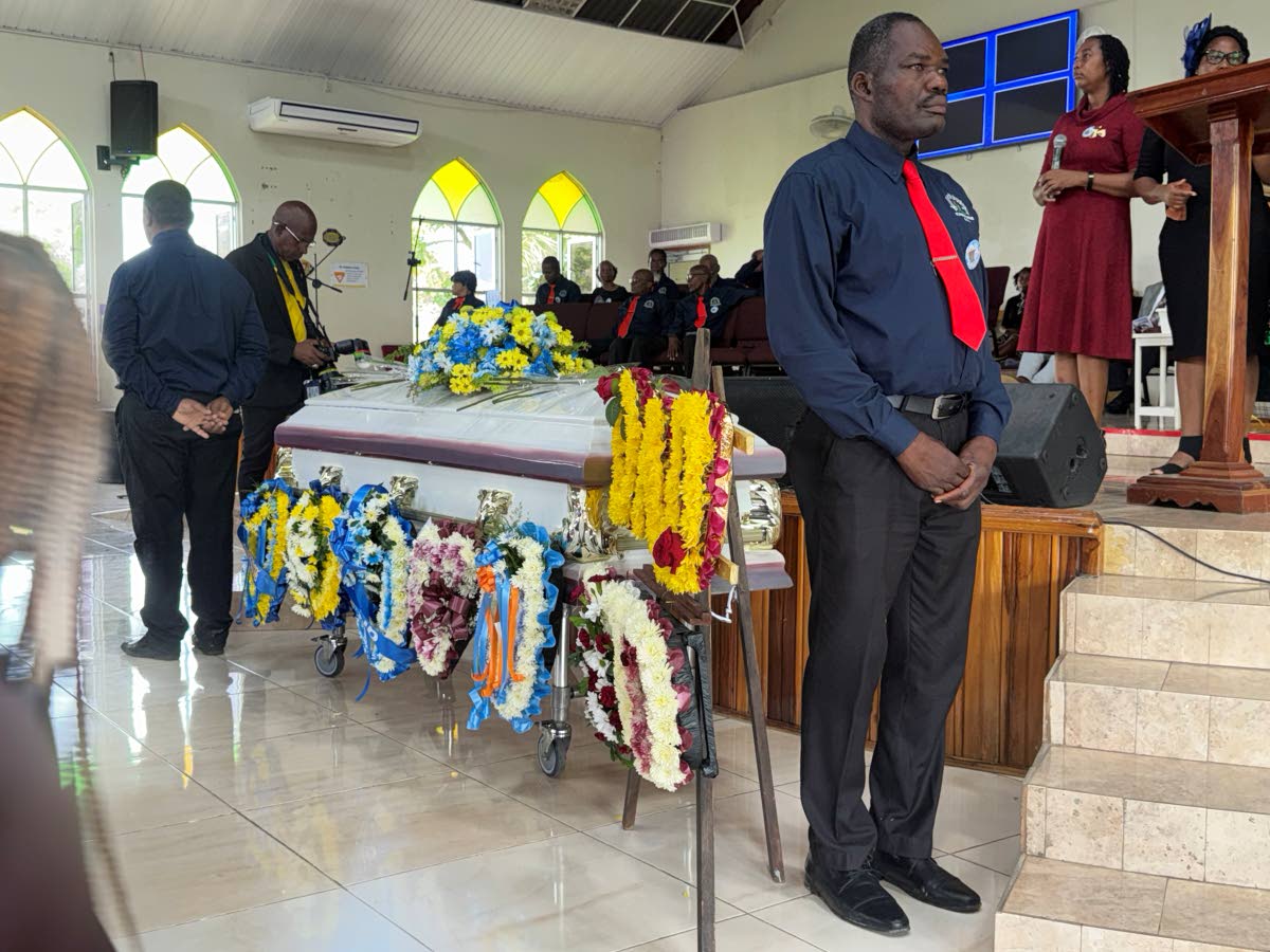 Members of the St James Men and Beams fraternity pay tribute to Jerry Reid inside the church. 