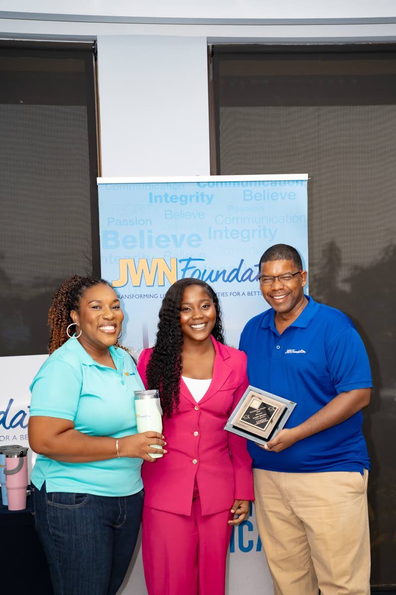 Chairman’s Medal Award recipient Lauren Wallfall (centre) receives her award from JWN Foundation directors Marsha Haughton (left) and Dwight Balli.